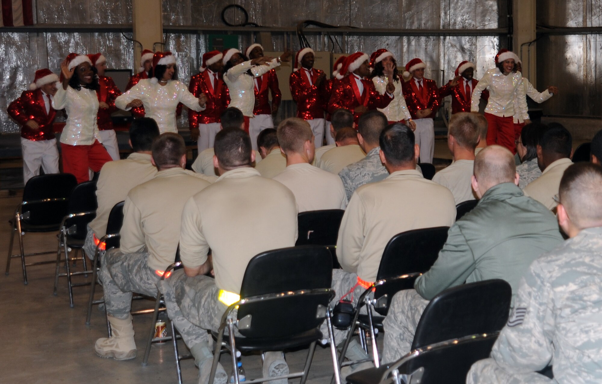 SOUTHWEST ASIA - Members of the Air Force entertainment group Tops in Blue perform their acoustic show in the middle of the night at the aerospace ground equipment hangar Dec. 21, 2001. After their final of three performances here, Tops in Blue takes its show on the road to several other installations in Southwest Asia. Tops in Blue has been performing for Airmen since 1953. (U.S. Air Force photo/Staff Sgt. J.G. Buzanowski)