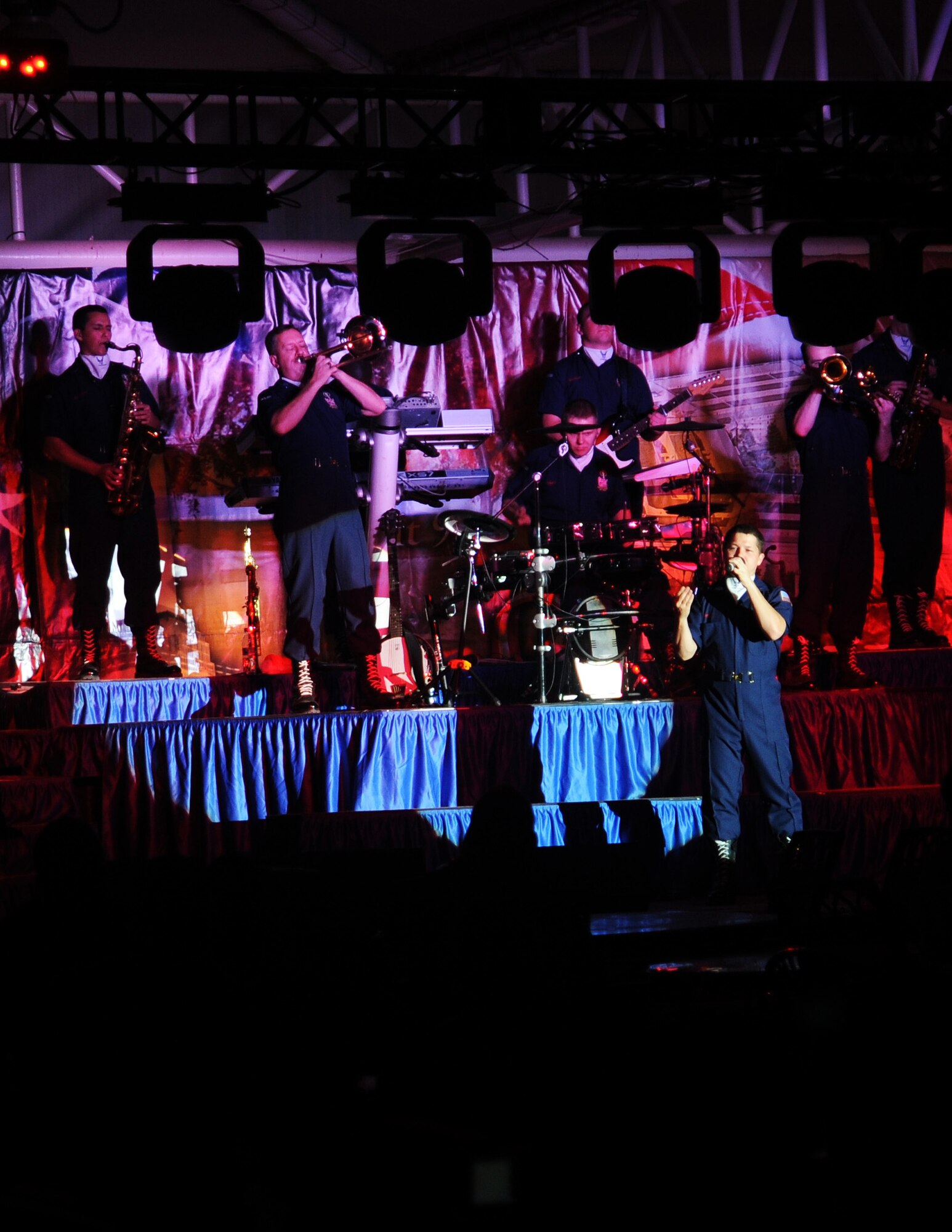 SOUTHWEST ASIA - Members of the Air Force entertainment group Tops in Blue  perform at the community activity center pavilion Dec. 21, 2001. While here, the troupe performed three shows for 380th Air Expeditionary Wing Airmen, including one in the middle of the night at the aerospace ground equipment hangar near the flightline. After their final performance here, Tops in Blue takes its show on the road to several other installations in Southwest Asia. During the year, Tops in Blue performs about 150 shows, with 25-30 of them at deployed locations. (U.S. Air Force photo/Staff Sgt. J.G. Buzanowski)
