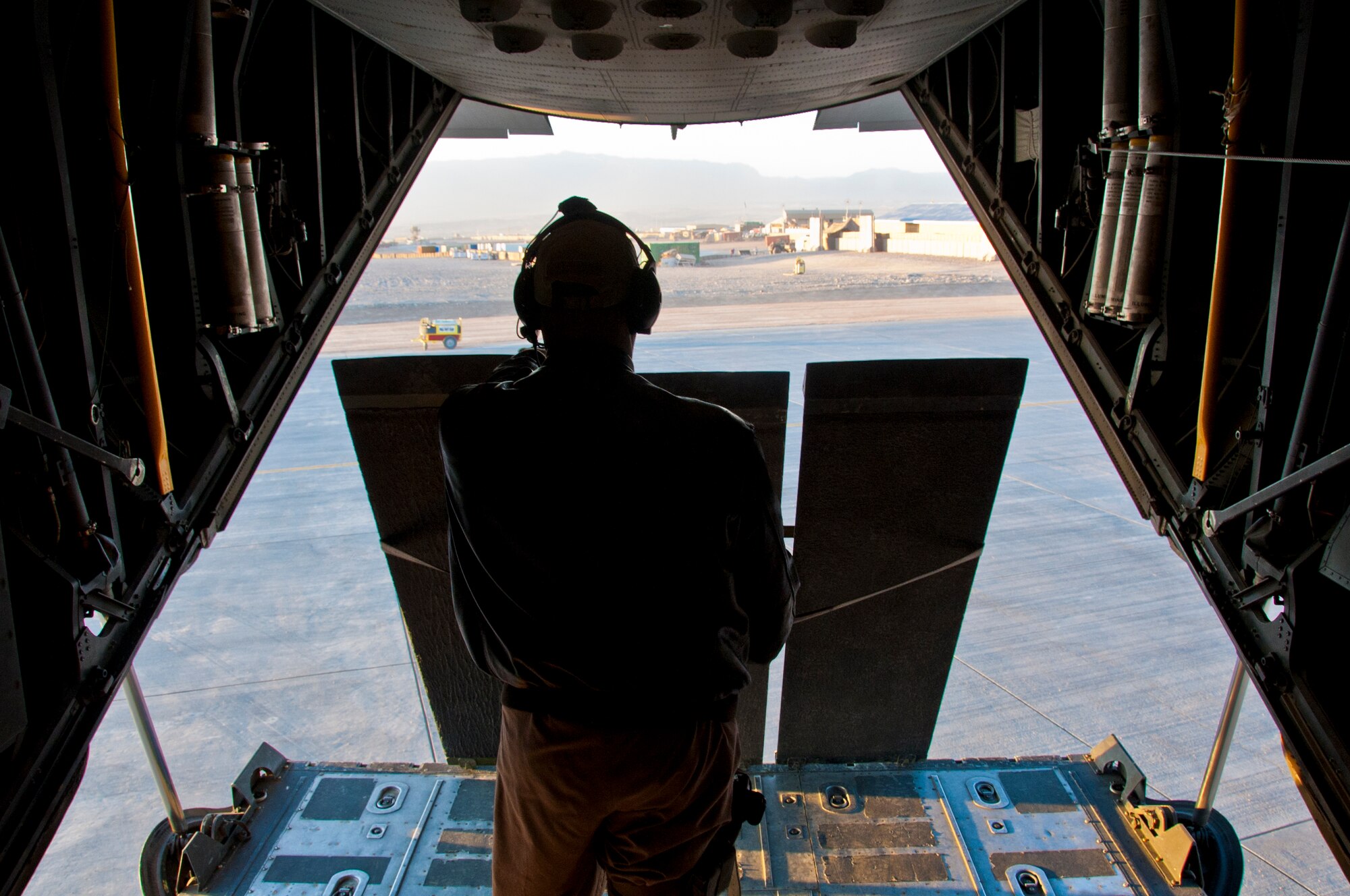 TARIN KOWT, Afghanistan -- A 76th Expeditionary Rescue Squadron loadmaster waits to lower the ramp to load a patient onto the HC-130P Combat King at Tarin Kowt, Afghanistan, Dec. 14, 2011. The two loadmasters assigned to the flight also help protect the patients, crew and the aircraft during a medical evacuation mission. (U.S. Air Force photo by Staff Sgt. David Carbajal)