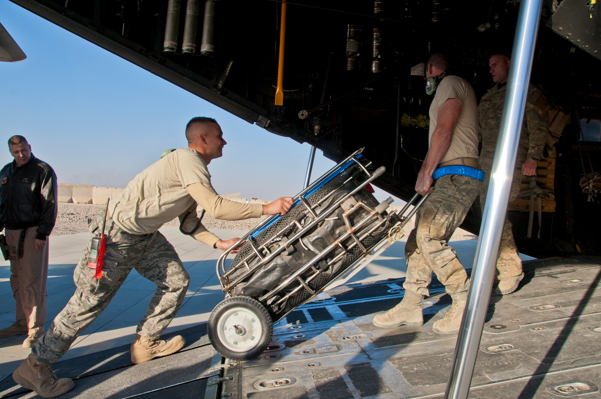 CAMP BASTION, Afghanistan -- Maintenance Airmen from the 76th Expeditionary Maintenance Squadron load equipment onto a HC-130P Combat King before a mission at Camp Bastion, Afghanistan, Dec. 14, 2011. Members of the 76th ERQS, nicknamed "Fever," fly into remote combat outposts, forward operating bases and camps to retrieve wounded personnel and transport them to more advanced medical treatment facilities like those at Bagram and Kandahar airfields. (U.S. Air Force photo by Staff Sgt. David Carbajal)