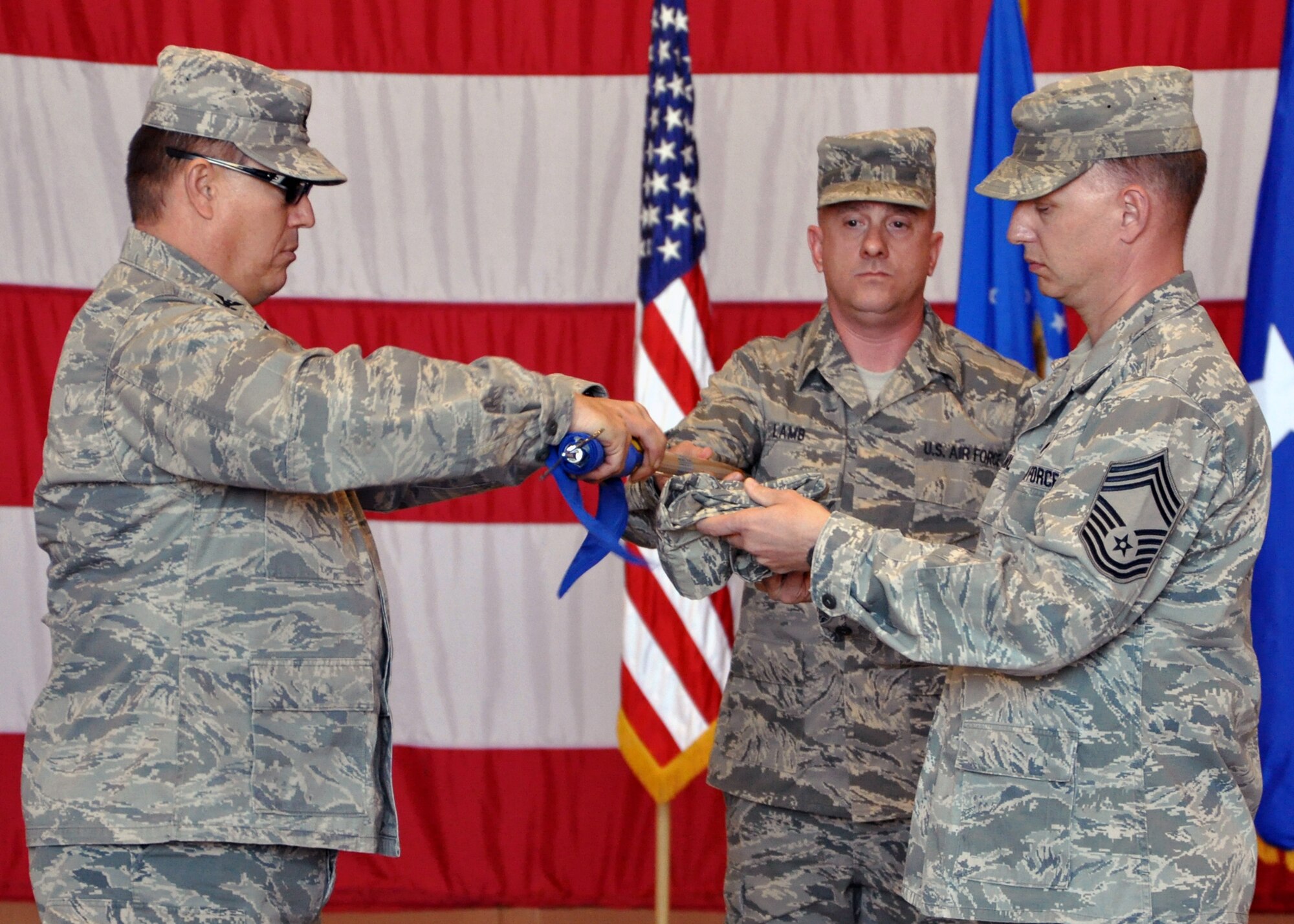 Col. Ralph Romine and Chief Master Sgt. Thomas Sokolnicki, 467th Air Expeditionary Group leadership, case the guideon for their unit during the 9th Air And Space Expeditionary Task Force-Iraq Inactivation Ceremony Dec. 18, 2011.  This was one of four unit inactivations during the ceremony, drawing the air and space mission of the 9th AETF-I to a close in Iraq.  (U.S. Air Force photo/Tech. Sgt. Stacy Fowler)