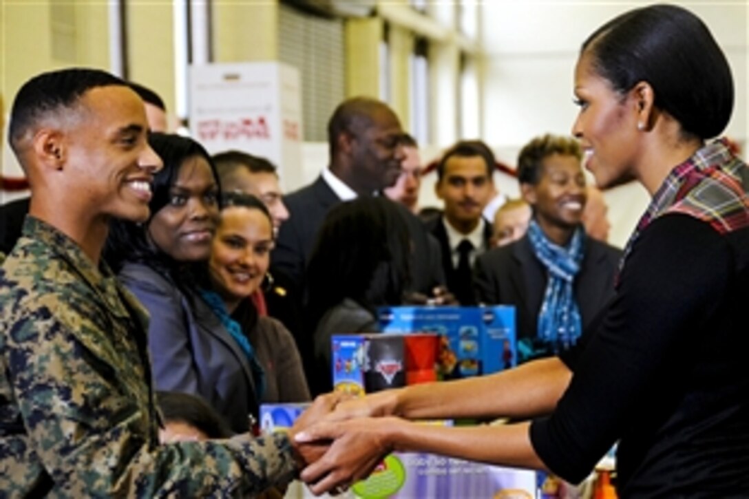 At a Toys for Tots event on Joint Base Anacostia-Bolling in Washington, D.C., Dec. 16, 2011, Marine Corps Lance Cpl. Aaron Leeks, left, took the opportunity to ask First Lady Michelle Obama to be his date at the annual Marine Corps ball next November -- with her husband’s permission, of course.