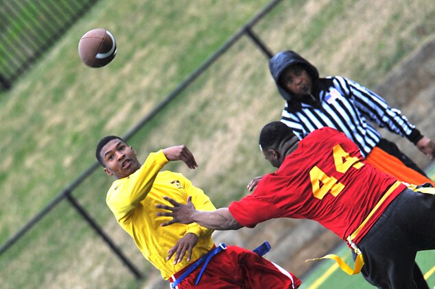 Brandon Mitchell, Headquarters & Service Company quarterback and cornerback, throws a pass while scrambling out of the pocket during the second half of Marine Barracks Washington’s intramural flag-football championship here Dec. 21. Mitchell threw for more than 100 yards in the game. His performance on offense and defense was a major factor in Team H&S’s 20-12 victory. (Official Marine Corps Photo by Cpl. Austin Hazard/Released)::r::::n::