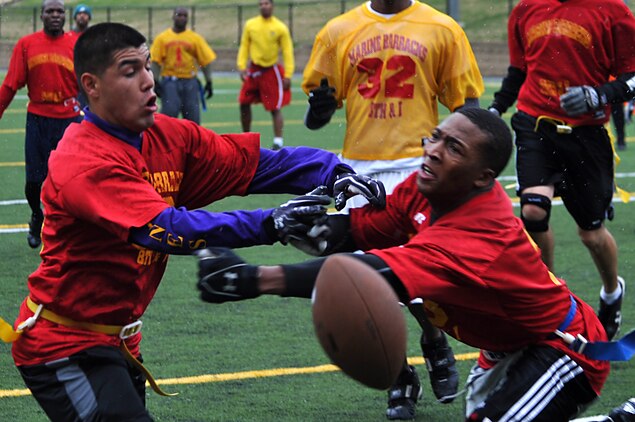 Kemond Tatum, Marine Corps Institute Company running back, and Christopher Bustamante, Team MCI wide receiver, almost collide after missing a touchdown catch during the second half of Marine Barracks Washington’s intramural flag-football championship here Dec. 21. Team MCI lost the championship game 12-20. (Official Marine Corps Photo by Cpl. Austin Hazard/Released)::r::::n::