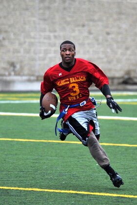 Kemond Tatum, Marine Corps Institute Company running back, rushes downfield catch during the second half of Marine Barracks Washington’s intramural flag-football championship here Dec. 21. Team MCI lost the championship game 12-20. (Official Marine Corps Photo by Cpl. Austin Hazard/Released)
