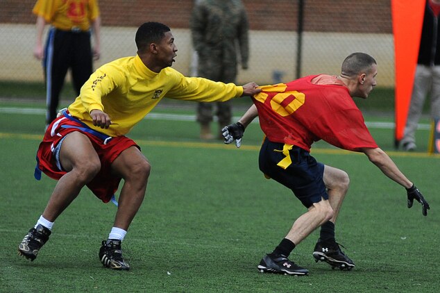 Brandon Mitchell, Headquarters & Service Company quarterback and cornerback, grabs Corey Quill’s (wide receiver) jersey during the first half of Marine Barracks Washington’s intramural flag-football championship. Dec. 21. Mitchell had no penalties on defense throughout the game, and his lock-down defense help seal the 20-12 win for Team H&S. (Official Marine Corps Photo by Lance Cpl. Mondo Lescaud/Released)::r::::n::