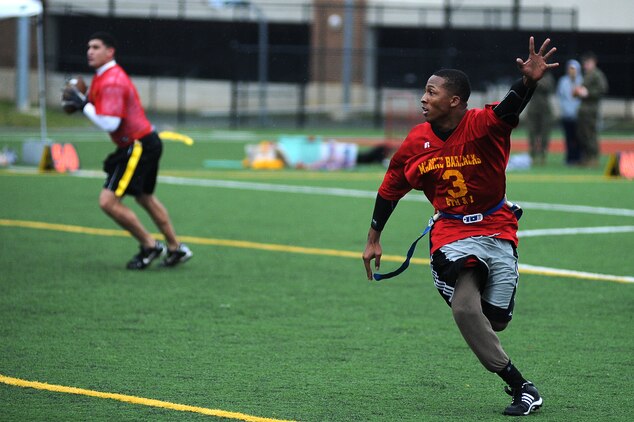 Kemond Tatum, Marine Corps Institute Company running back, signals for the screen pass during the first half of Marine Barracks Washington’s intramural flag-football championship Dec. 21. Tatum also played linebacker for Team MCI, which lost the game by eight points.  (Official Marine Corps Photo by Lance Cpl. Mondo Lescaud/Released)::r::::n::
