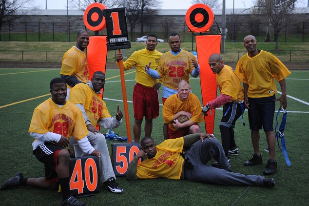 Players from Headquarters & Service Company stand victoriously at mid-field after Marine Barracks Washington’s intramural flag-football championship Dec. 21. H&S Co. faced off against Marine Corps Institute Company in a gritty, competitive game, but came out on top 20-12.