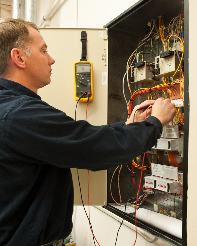 Clinton Peterson, 28th Civil Engineer Squadron industrial electronic control technician, uses a voltage meter to ensure a control box is operating properly on Ellsworth Air Force Base, S.D., Dec. 22, 2011. Airmen from the 28th CES routinely check the circuit boxes at facilities across the base to guarantee boilers and heaters are working correctly. (U.S. Air Force photo by Airman Alystria Maurer/Released)