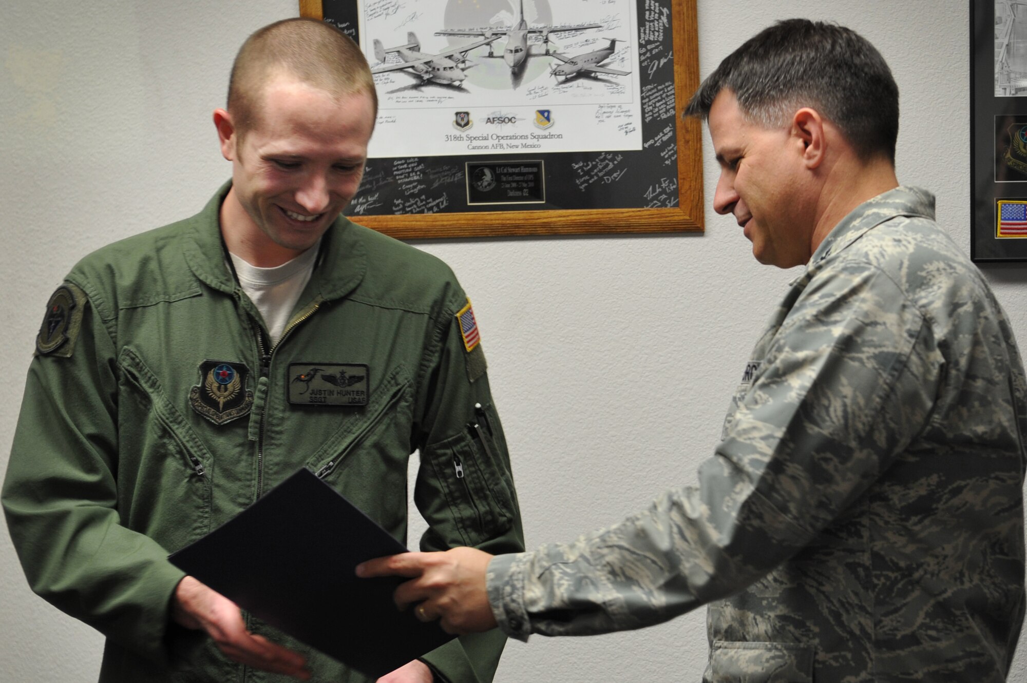 Staff Sgt. Justin Hunter, 3rd Special Operations Squadron standardization and evaluations, is promoted to Tech. Sgt. by Col. Buck Elton, 27th Special Operations Wing commander, at Cannon Air Force Base, N.M., Dec. 22, 2011.  The new technical sergeant earned his STEP promotion, or Stripes for Exceptional Performers, based on his potential to serve at a higher rank. (U.S. Air Force photo by Senior Airman Jette Carr)
