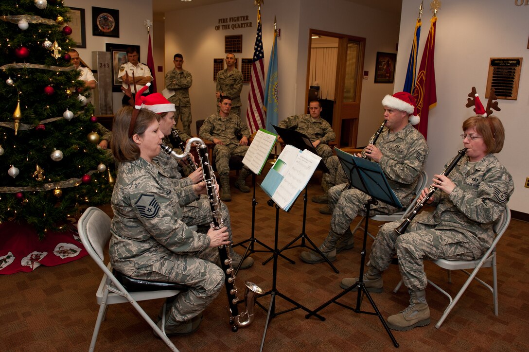 Air Combat Command Heartland Band of America's New Horizons, a clarinet quartet, performs Christmas carols in the foyer of the Fire Station on Ellsworth Air Force Base, S.D., Dec. 15, 2011. The troupe traveled around base for two days performing at various locations spreading holiday cheer and thanking Airmen for their hard work. (U.S. Air Force photo by Airman 1st Class Kate Thornton/Released)