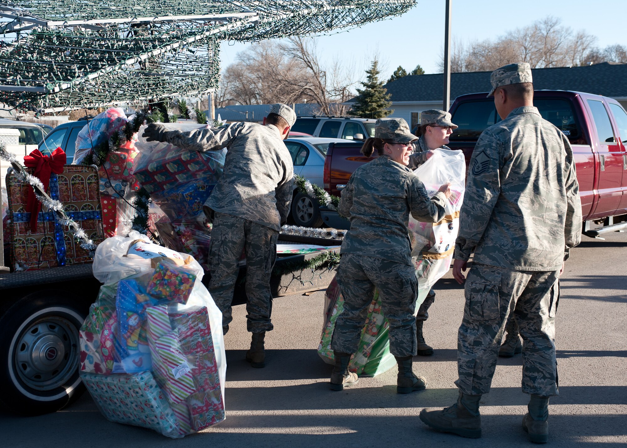 Volunteers from Ellsworth Air Force Base, S.D. unload more than 180 presents from Santa's sleigh to take into the classrooms at the Youth & Family Services Child Care program in Rapid City, S.D., Dec. 15, 2011. This is the fifth year the 28th Operations Group has conducted an Angel Tree program. (U.S. Air Force photo by Airman Alystria Maurer/Released)