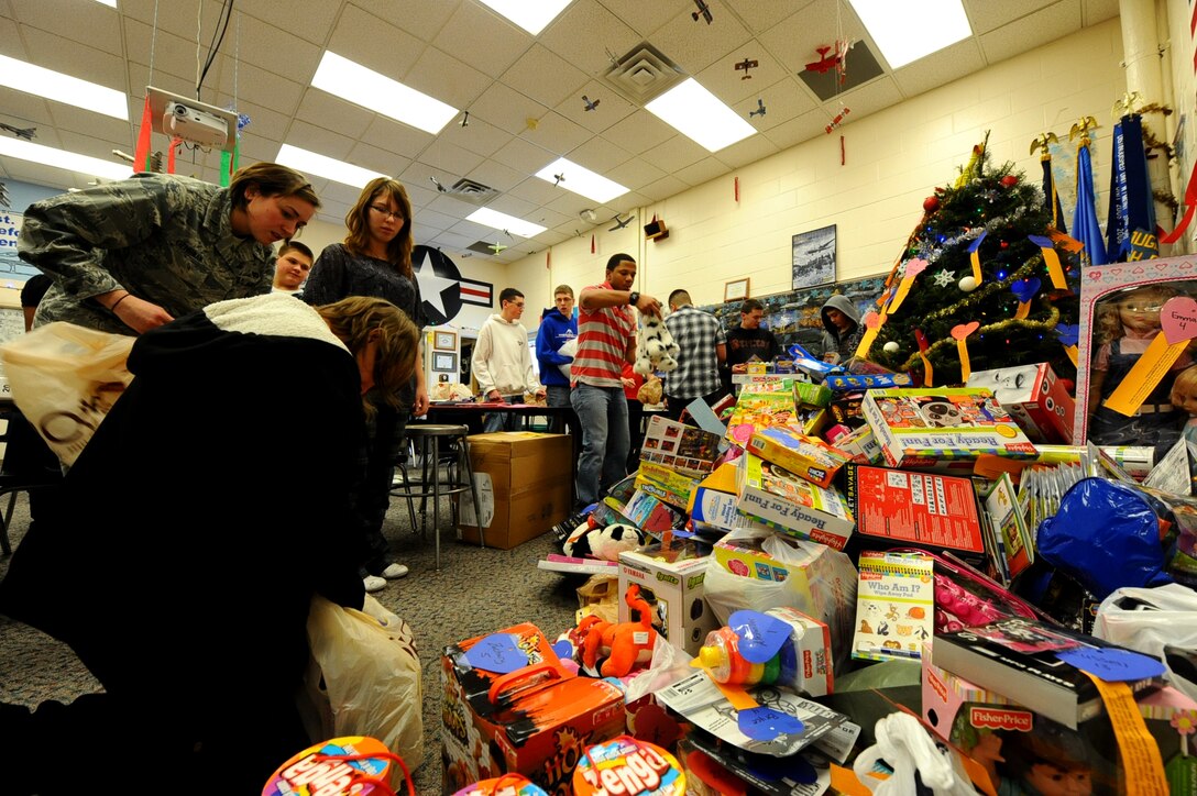 First Lt. Rebecca Gehrman, 28th Civil Engineer Squadron programs deputy flight chief, helps unload more than 150 toys and gifts collected as part of the annual Gifts from the Heart program at Douglas High School in Box Elder, S.D., Dec. 13, 2011. More than 150 people donated toys and gifts for underprivileged children in the local area. (U.S. Air Force photo by Airman 1st Class Zachary Hada/Released)