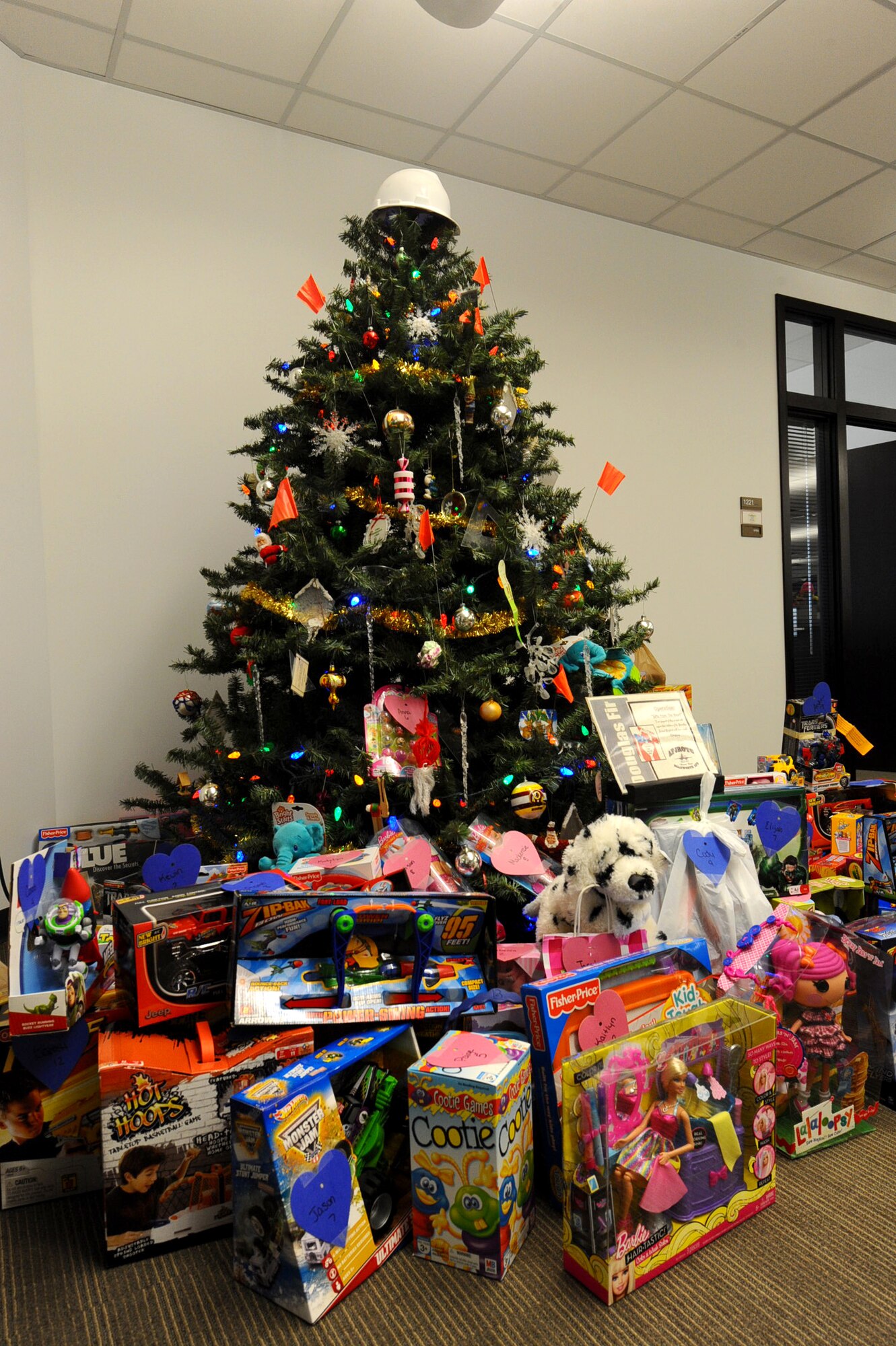 The Gifts from the Heart tree at the 28th Civil Engineer Squadron headquarters building is surrounded with gifts donated by Airmen and their families at Ellsworth Air Force Base, S.D., Dec. 13, 2011. More than 150 gifts were gathered and provided to the Douglas High School Junior Reserve Officer Training Corps program in Box Elder, S.D. who will distribute them to underprivileged children in the area. (U.S. Air Force photo by Airman 1st Class Zachary Hada/Released)