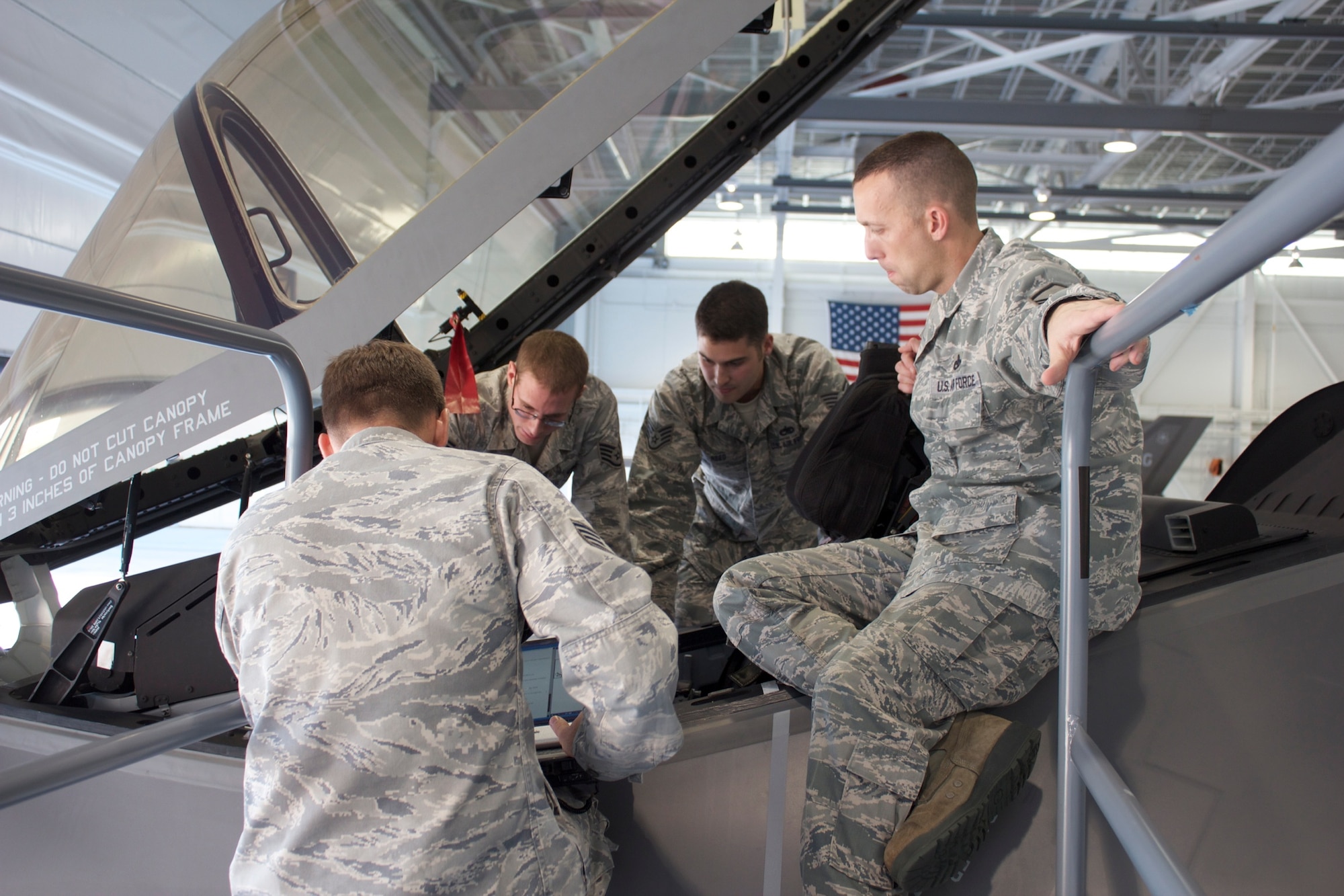 Staff Sgt.s Jonathan Morris, Andrew Fries, Matthew Reed and Master Sgt. Scott Grabham, of the 58th Aircraft Maintenance Unit, receive training on F-35A crew station post operations inspections Dec. 12. They are part of the first group of military joint strike fighter maintainers at the 33rd Fighter Wing qualified in numerous F-35A flight inspections initially provided by contractor support. (U.S. Air Force photo/Staff Sgt. Jason Westberry)