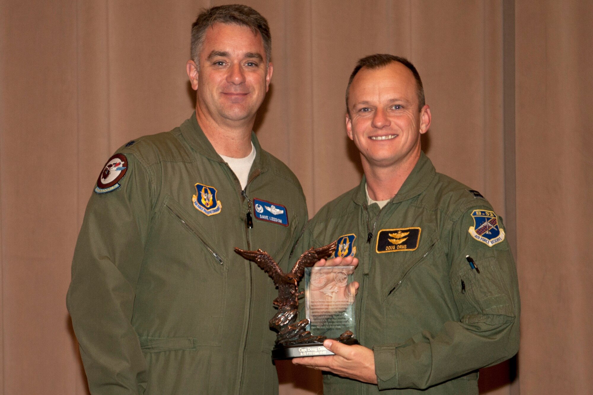 U.S. Air Force Lt. Col. Dave Leedom, 93rd Bomb Squadron commander, presents the Lindell Mabus Leadership Award to Capt. Michael Orms during a 93rd BS Formal Training Unit graduation ceremony, Barksdale Air Force Base, La., Dec. 22, 2011. Orms was chosen by fellow classmates as their outstanding leader during B-52 aircrew training. (U.S. Air Force photo by Master Sgt. Greg Steele/Released)