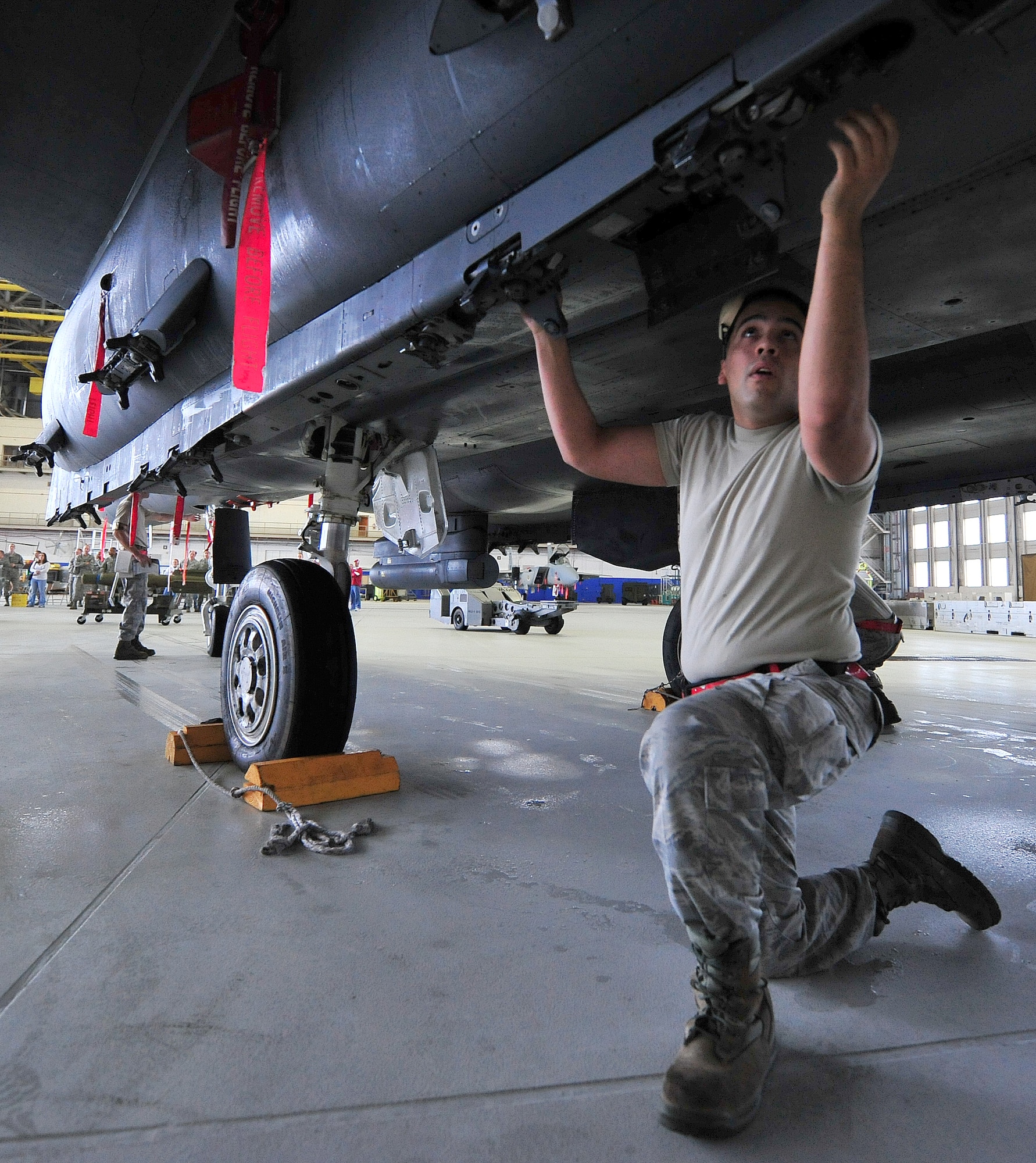 Airman 1st Class Christopher Rose, of the 46th Aircraft Maintenance Squadron, prepares the aircraft during the 46th Maintenance Group’s fourth quarter weapons load competition at Eglin Air Force Base, Fla., Dec. 21. The best of Blue AMU and Red AMU met to load an AIM-9 and GBU-12 onto an F-16 and F-15 respectively. AMU Red won the competition. (U.S. Air Force photo/Randy Gon) 