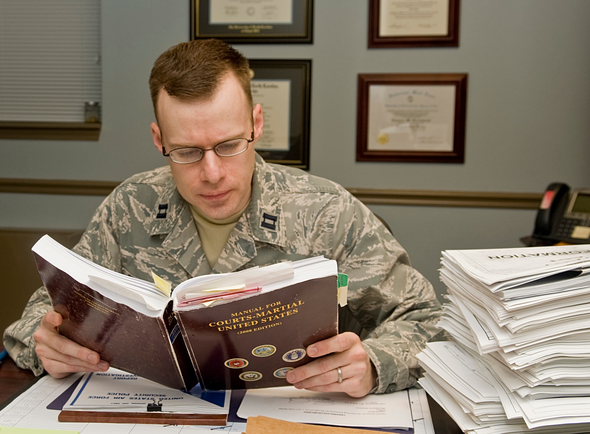 Capt. Thomas Greenwood, Area Defense Counsel Judge Advocate, reads from a Manual for Courts-Martial in his office on Barksdale Air Force Base, La., Dec. 15. The ADC provides a free service to Air Force members facing administrative or judicial actions including courts-martial, Uniform Code of Military Justice rights advisement, administrative discharges and non-judicial punishment proceedings. (U.S. Air Force photo/Senior Airman Kristin High)(RELEASED)