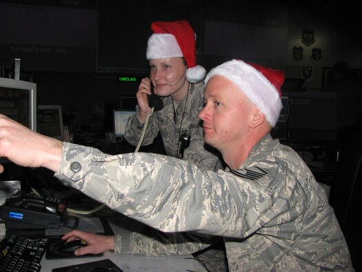 Master Sgt. Chad Gerrard points out a radar track to Staff Sgt. Kristen Smith, who prepares to relay the information during practice for Santa's tracking operations at the Eastern Air Defense Sector in Rome. A New York Air National Guard unit, EADS is a part of the North American Aerospace Defense Command (NORAD) and supports NORAD’s Santa tracking mission every Christmas Eve. 
 
