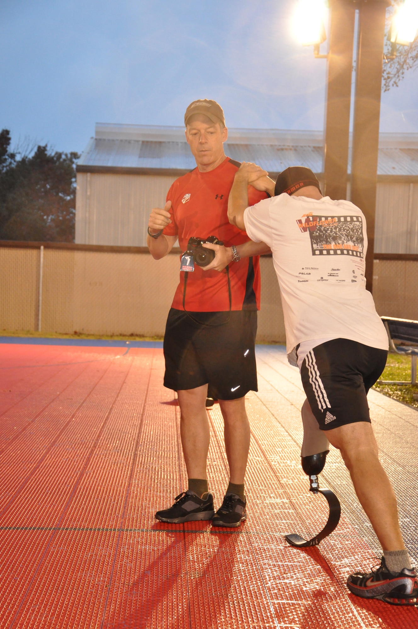 LACKLAND AIR FORCE BASE, Texas — Chad Crittenden, part of the American300 Warrior Tour and a CBS’ Survivor contestant, braces himself on the shoulder of Robi Powers, founder of American300, to stretch out his calf before working out with members of 24th Air Force here Dec. 19. The American300 Warrior Tours is an all-volunteer, nonprofit organization dedicated to raising the resiliency of American military members, their families and the communities in which they live. (U.S. Air Force photo by William Parks)