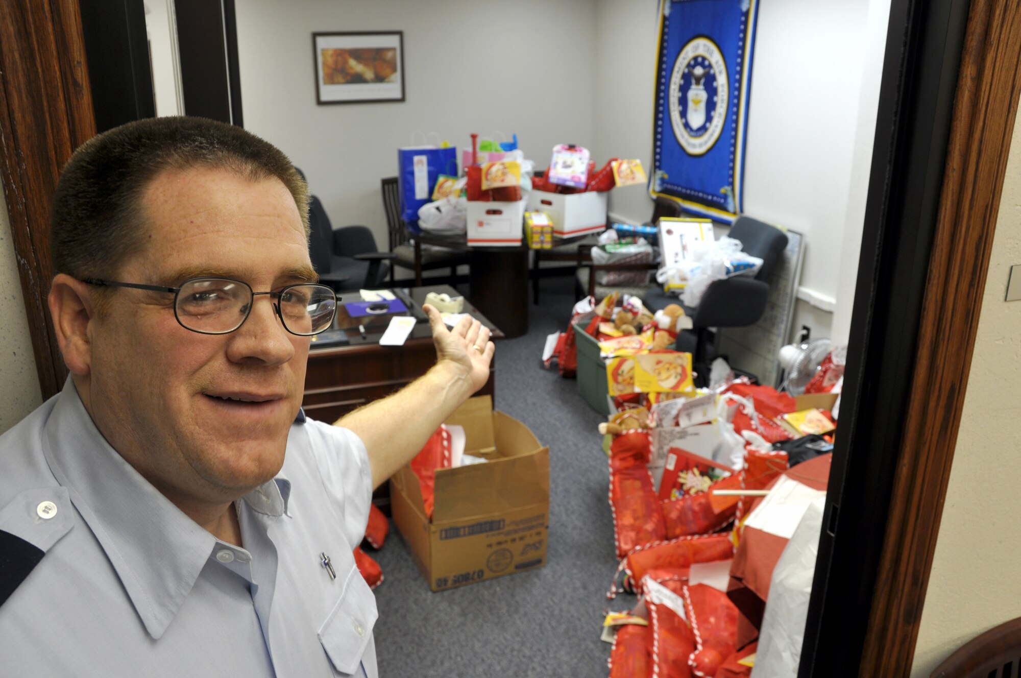 507th Air Refueling Wing Chaplain (Major) Dwight Magnus shows off some of the more than 300 Christmas stockings his office gathered this year in support of the Salvation Army Christmas Stocking program.  Air Force Reserve volunteers from across the wing stepped up to fill each stocking which are destined to be delivered to an area child for Christmas.