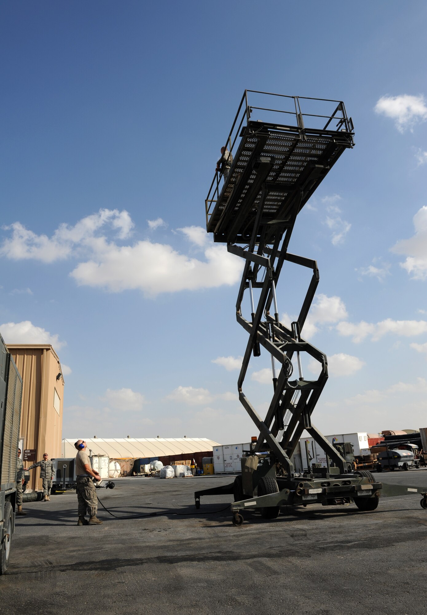 SOUTHWEST ASIA – Staff Sgt. Joshua Zito, 379th Expeditionary Maintenance Squadron aerospace ground equipment (AGE) mechanic and native of Vacaville, Calif., demonstrates the capabilities of a universal maintenance stand to 379th Air Expeditionary Wing leadership here Dec. 21, 2011. Zito is deployed from Travis Air Force Base, Calif. (U.S. Air Force photo/Staff Sgt. Nathanael Callon)