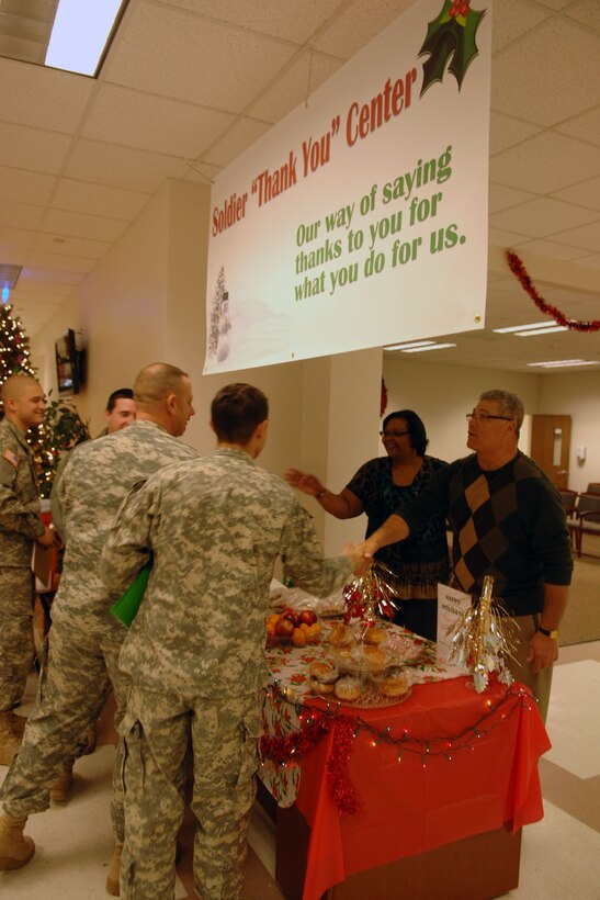 Soldiers take free snacks from the “Soldier ‘Thank You’ Center” table Dec. 15 at the Fort  Eustis 733rd Mission Support  Group Soldier Support Center. Lani Gates of the Military Personnel Branch of the SSC came up with the idea for the “Soldier ‘Thank You’ Center” and all the staff at the SSC pitched in as a way of thanking servicemembers during the holiday season for all they do for their country. (U.S. Air Force photo by Staff Sgt. Jeff Nevison/Released)