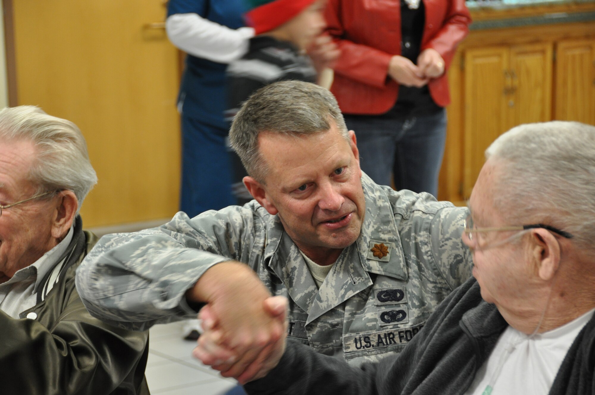 Major Dennis Sivert, 507th Logistics Readiness Squadron commander, chats with one of the residents of the Norman, Oklahoma, Veteran's Center December 20th during a Center Christmas party.  Sivert is a member of the 507th Air Refueling Wing which operates an annual effort to ensure each of the 300 center residents receive a Christmas present and are not forgotten.