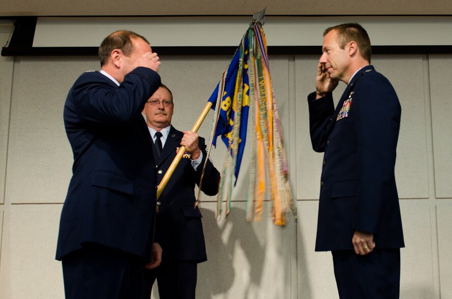 Lt. Col. Coy Riecker (right), 180th Airlift Squadron commander, salutes Col. Ralph Schwader, 139th Airlift Wing vice commander, during a change of command ceremony Dec. 4, 2011 at Rosecrans Air National Guard Base, St. Joseph, Mo. (MIssouri Air National Guard photo by Senior Airman Kelsey Stuart)