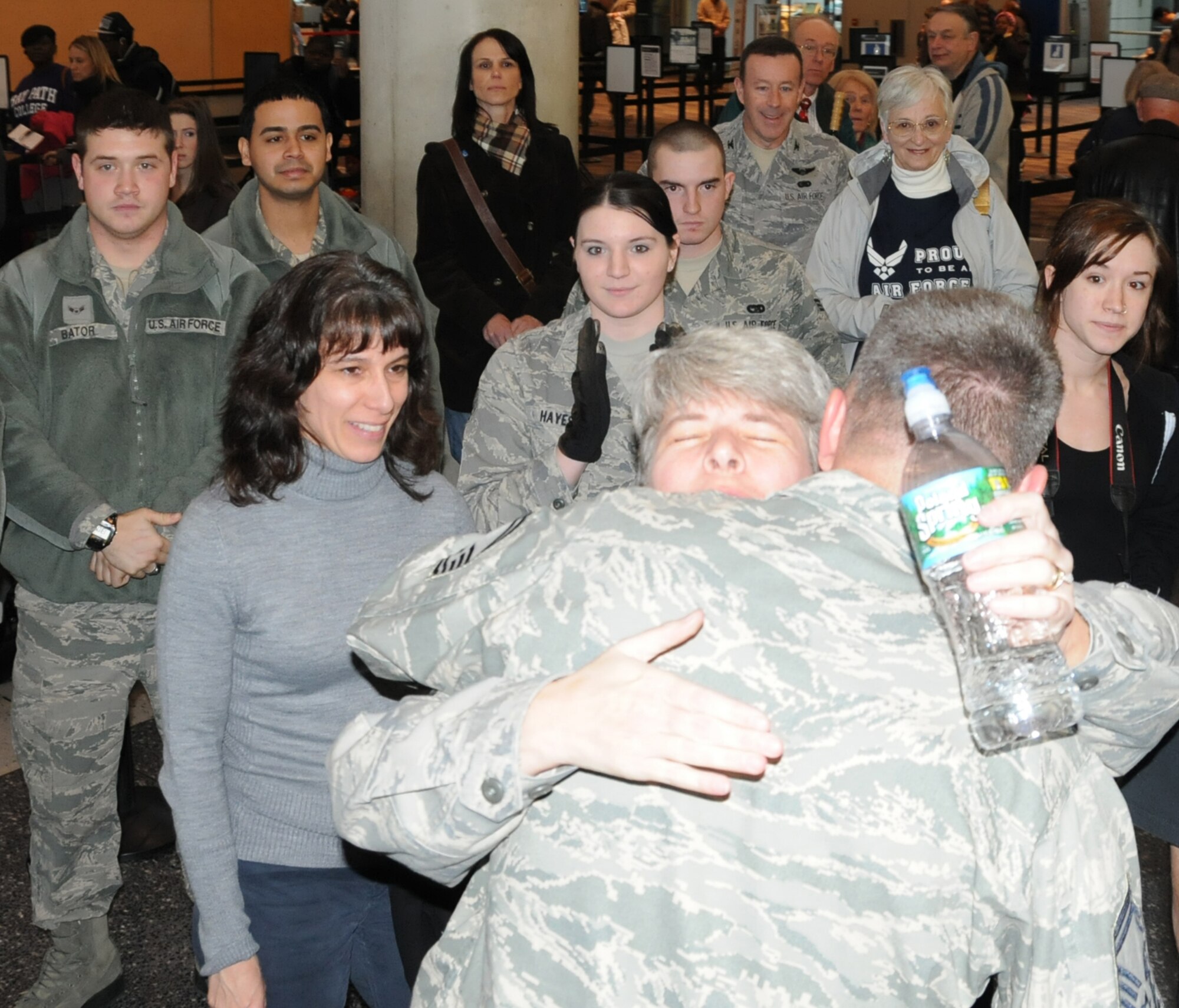 SMSgt. Gerilyn Ridzon, 439th Logistics Readiness Squadron, hugs SMSgt. Michael Barna, fellow squadron member and returning deployer, Dec. 21 at Bradley International Airport, Windsor Locks, Conn. SMSgt. Barna returned home to his family and LRS members following a six-month deployment to Iraq, where he was part of closing American military operations at Baghdad Internationall Airport. (US Air Force photo/MSgt. Andrew Biscoe)
