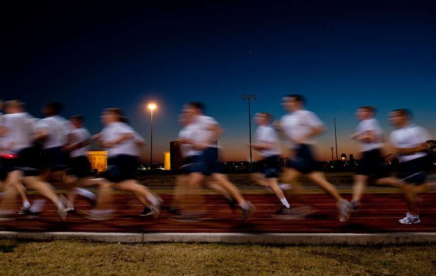 Airmen run as a group around the east gate track Dec. 15 at Eglin Air Force Base, Fla.  The track is one of three available to anyone with access to the base.  There are also nature trails and cross-country paths scattered throughout the base.  (U.S. Air Force photo/Samuel King Jr.)