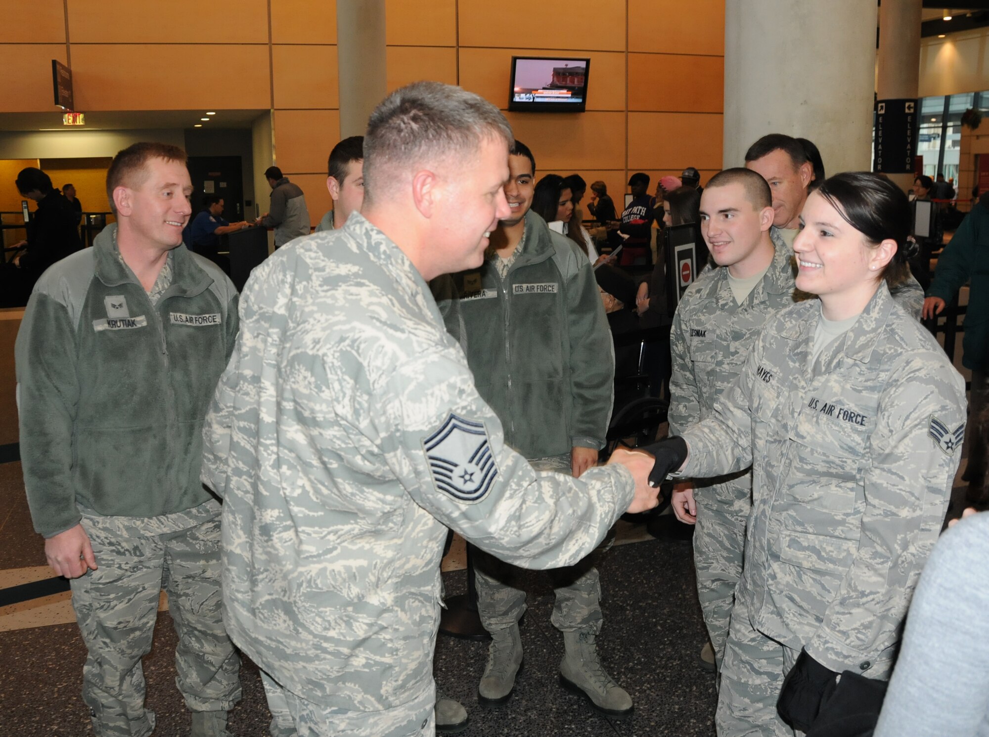 SrA. Alicia Hayes, 439th Logistics Readiness Squadron, welcomes SMSgt. Michael Barna home from his six-month deployment to Iraq. SrA. Hayes was among a cadre of LRS Airmen to travel to Bradley International Airport to welcome home SMSgt. Barna. (US Air Force photo/MSgt. Andrew Biscoe)