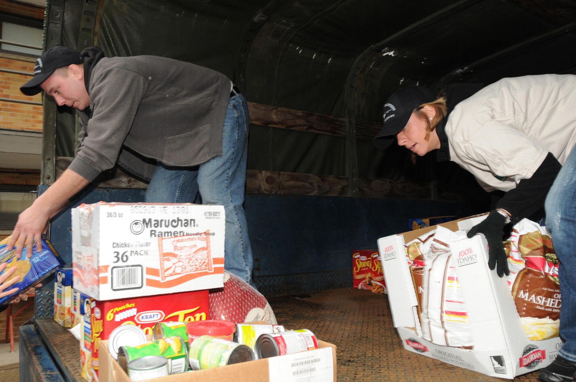 Airmen from the 107th Airlift Wing along with mission staff unloaded boxes of food, canned goods and frozen turkeys stocking up the food pantry at the Niagara Falls Community Mission. Airman 1st Class Tony Lewandowski  and Tech. Sgt. Krystatore Stegner  help with the unload of goods to the volunteers on December 21, 2011 (Air Force Photo/Senior Master Sgt. Ray Lloyd)

