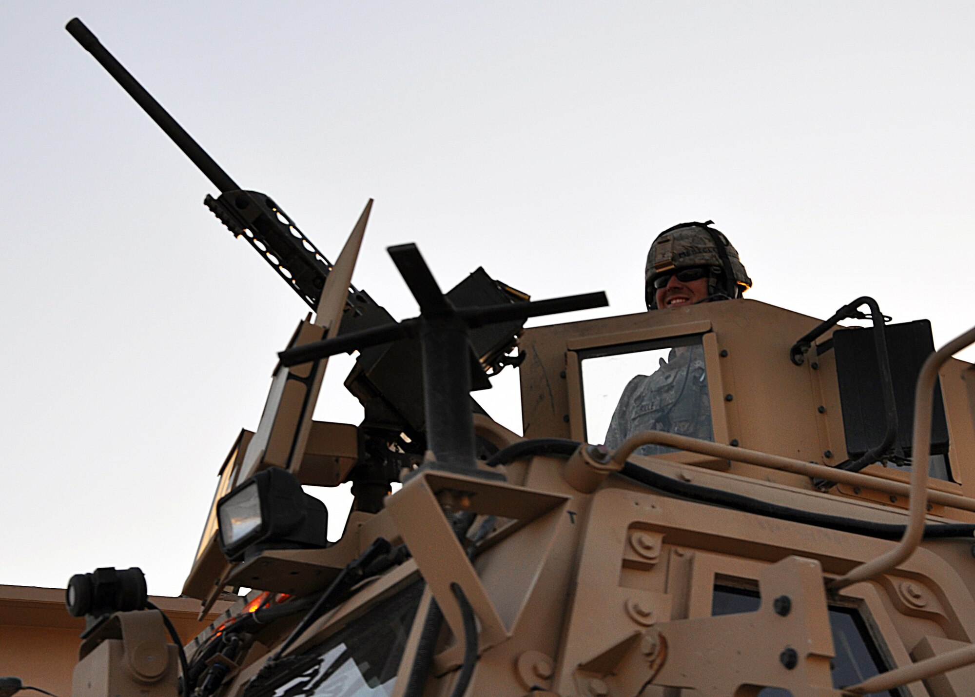The gunner of a gun truck in last convoy of the 387th Expeditionary Logistics Readiness Squadron's "Convoy Truckers" smiles as he sees the end of the road to the mission in Iraq Dec. 17, 2011.  The 387th ELRS's Airmen worked closely with U.S. and Iraqi military branches to enable an organized drawdown and transport of equipment out of Iraq. (U.S. Air Force photo/Tech. Sgt. Stacy Fowler)