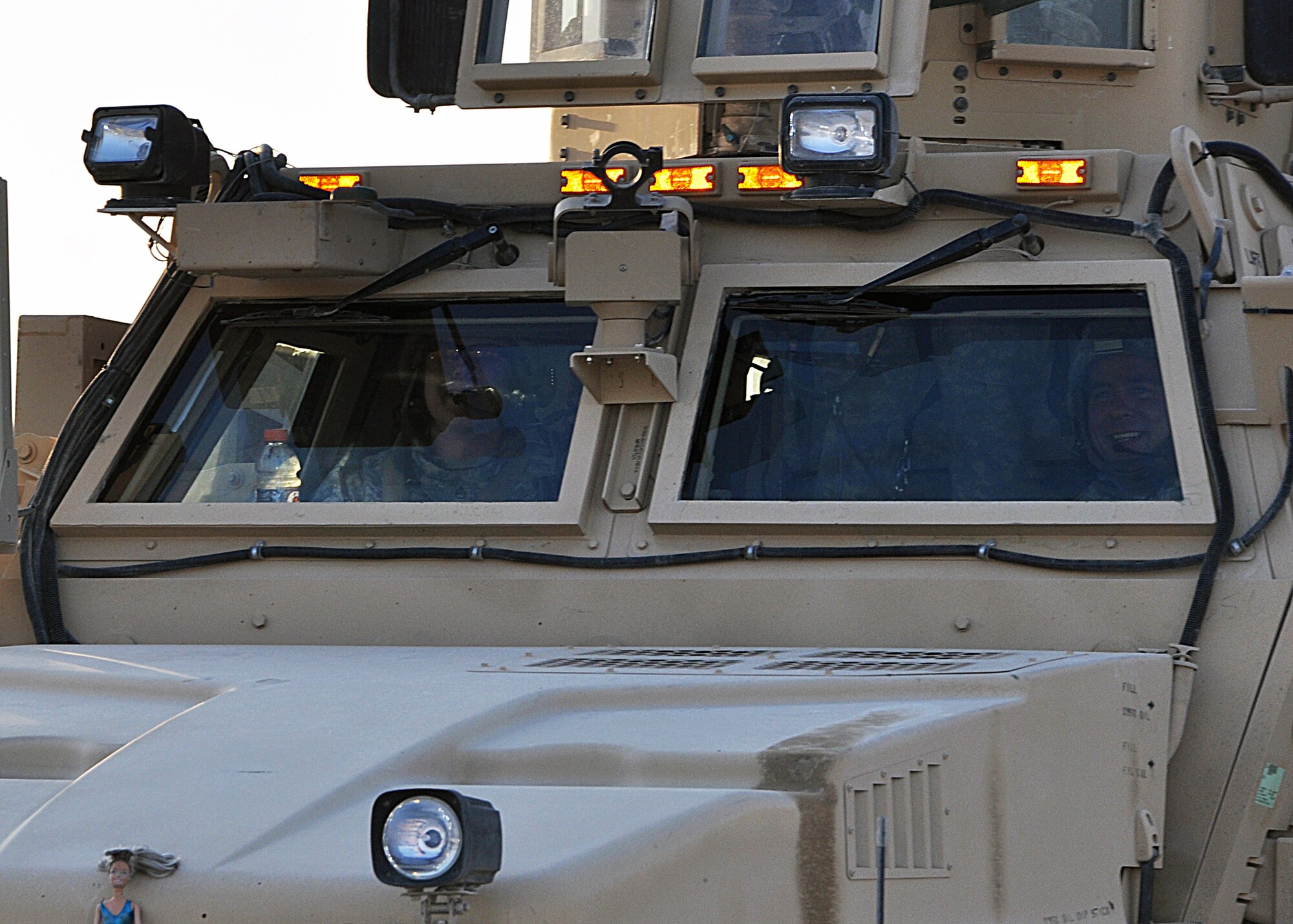 The driver and his truck commander of a gun truck in last convoy of the 387th Expeditionary Logistics Readiness Squadron's "Convoy Truckers" have big smile as he leaves Iraq for the last time Dec. 17, 2011.  Thousands of Airmen and Soldiers in the 387th ELRS have transported equipment into and out of Iraq for eight years, and their mission has finally come to an end. (U.S. Air Force photo/Tech. Sgt. Stacy Fowler)