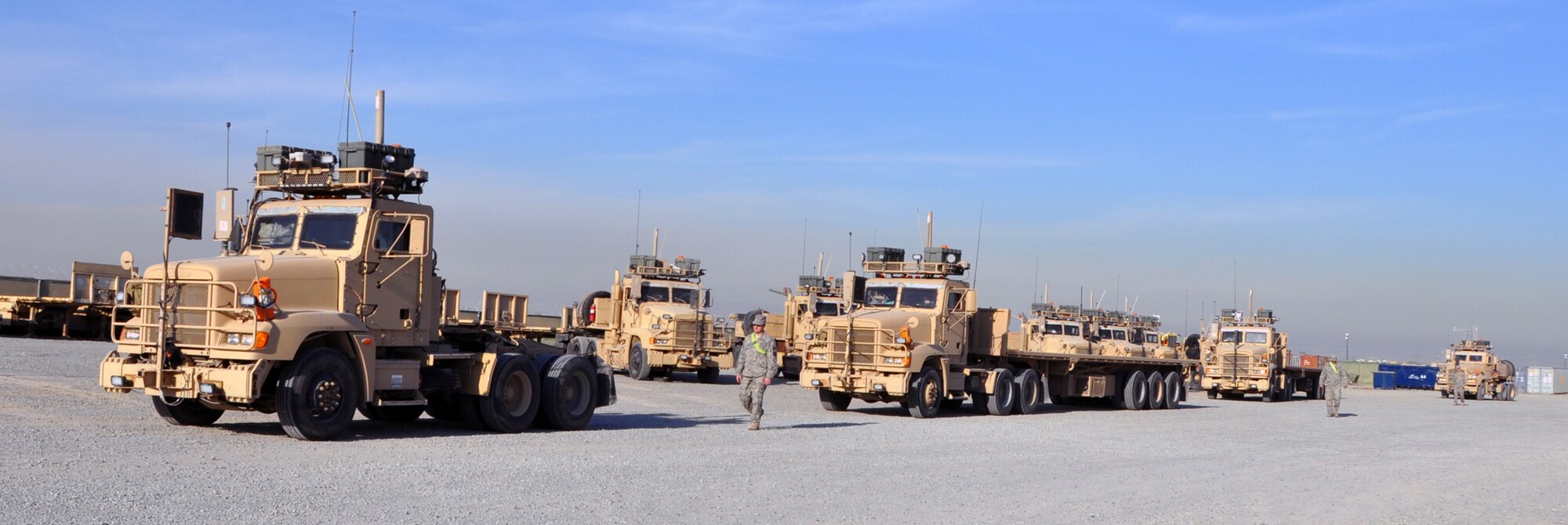 Airmen with the 387th Expeditionary Logistics Readiness Squadron guide their empty trucks out of the 387th ELRS compound for the last convoy into Iraq Dec. 14, 2011.  The 387th ELRS "Combat Truckers" have been transporting U.S. equipment out of Iraq for months, preparing for the final drawdown which is scheduled to be complete by Dec. 31, 2011. (U.S. Air Force photo/TSgt. Stacy Fowler)