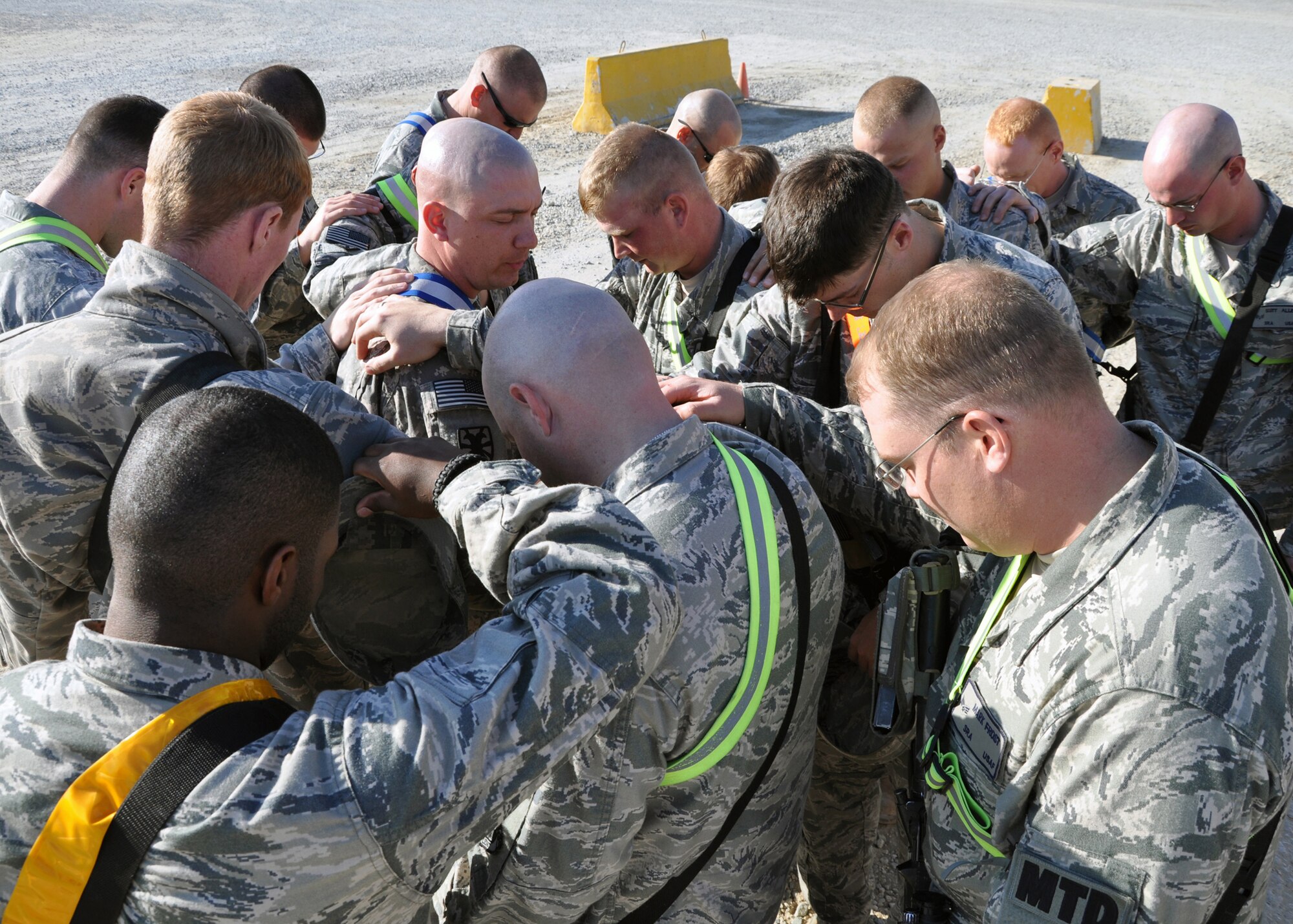 The last group of personnel with the 387th Expeditionary Logistics Readiness Squadron's "Convoy Truckers" take a moment for prayer before leaving the compound on their last mission into Iraq Dec. 14, 2011, Southwest Asia.  With thousands of Airmen and Soldiers, the 387th ELRS has transported equipment into and out of Iraq for eight years, and its mission has finally come to an end. (U.S. Air Force photo/Tech. Sgt. Stacy Fowler)