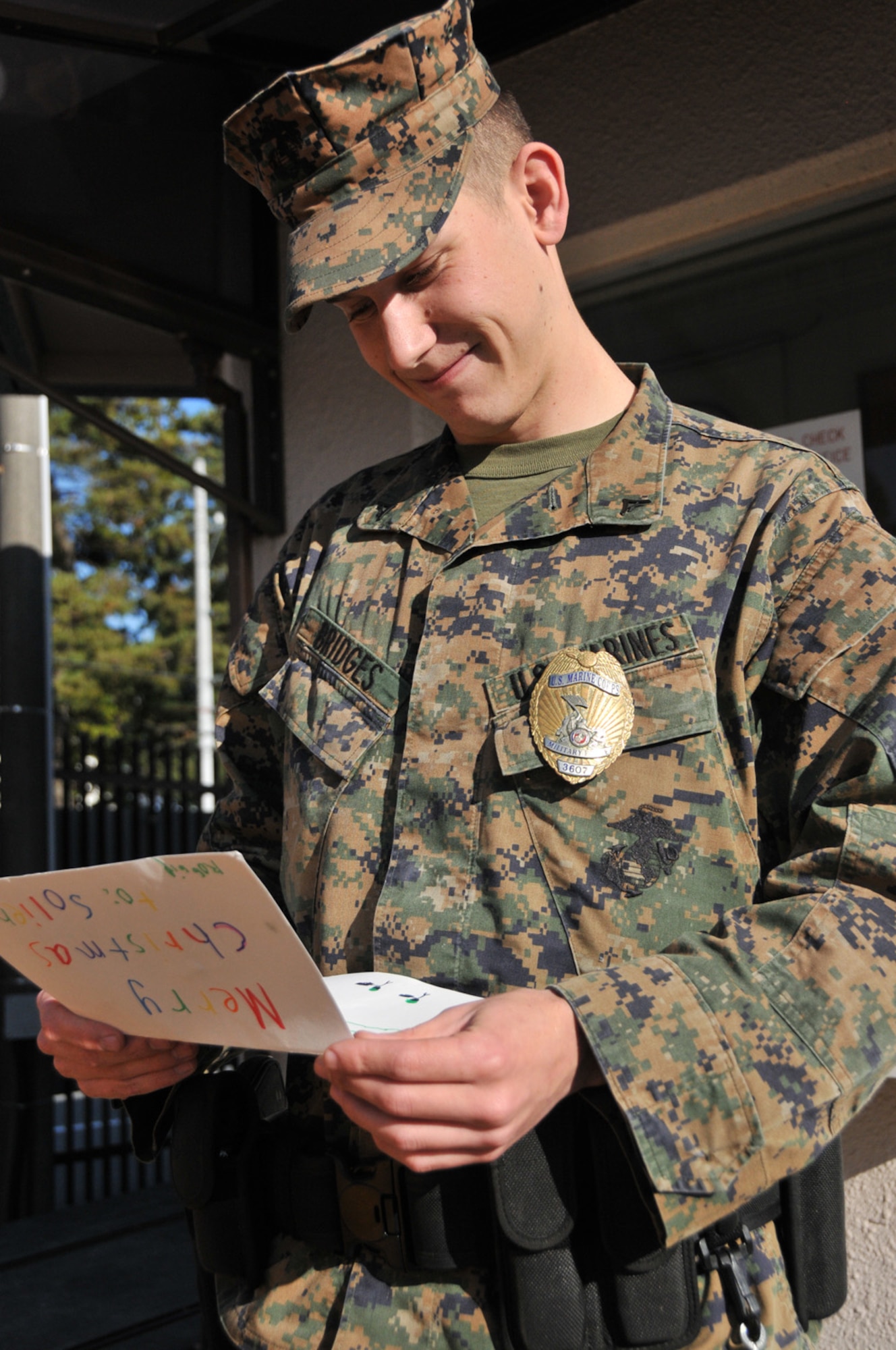 CAMP FUJI, Japan -- Lance Cpl. Aaron Bridges, Camp Fuji Provost Marshal's office, reads a Christmas card he received from the Yokota American Red Cross at Camp Fuji, Japan, Dec. 16, 2011. The Yokota ARC distributed more than 7,000 holiday cards to service members at Yokota Air Base and Camp Fuji, Japan. Cards were sent to the ARC through the Holiday Mail for Heroes program. (U.S. Air Force photo/Airman 1st Class Desiree Economides)