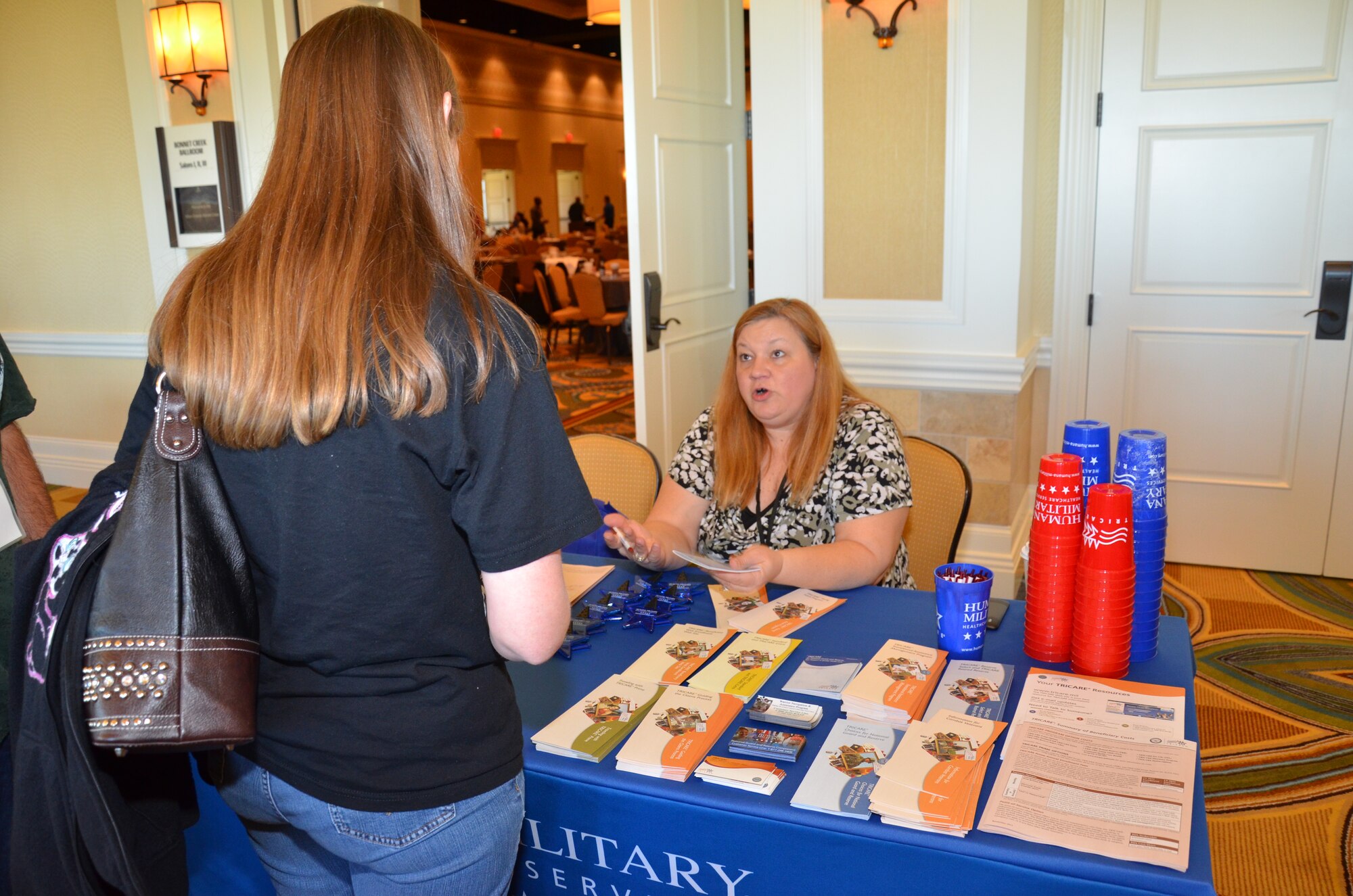 A community partner speaks with an attendee at Air Force Reserve Command’s Yellow Ribbon event in Orlando, Fla., Dec. 17, 2011. The Yellow Ribbon Program was initiated by the Secretary of Defense and mandated by Congress in 2008 to provide information, services, referral and proactive outreach programs to Reservists and Guardsmen and their dependents through all phases of deployment cycles. (U.S. Air Force photo/Staff Sgt. Anna-Marie Wyant)