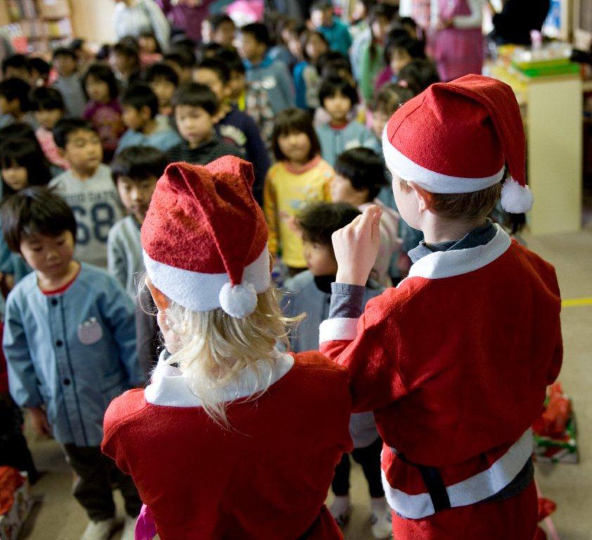 MIYAGI-KEN, Japan -- Santa's little helpers, children of Nathan Frost, U.S. Forces Japan, lead students from Fuji Kindergarten in a Christmas carol, Dec. 15, 2011. More than 25 Yokota members visited the kindergarten, which was largely affected by the 9.0-magnitude earthquake and subsequent tsunami on March 11, 2011. (U.S. Air Force photo/Airman 1st Class Krystal Garrett)