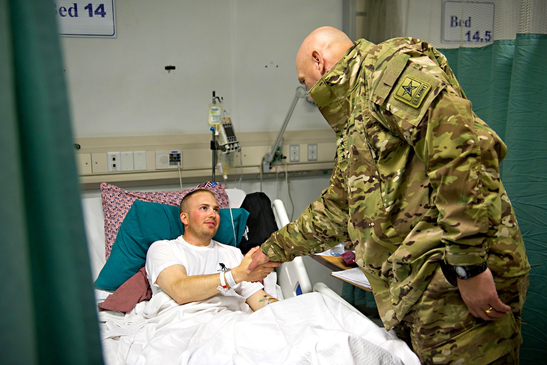 U.S. Army 1st Lt. Casey Wolfe shakes hands with U.S. Army Chief of Staff Gen. Raymond T. Odierno at SSG Heathe N. Craig Joint Theater Military Hospital in Bagram Airfield, Afghanistan, Dec. 20, 2011. Wolfe is assigned to the 1st Infantry Division's 4th Squadron, 4th Cavalry Regiment.