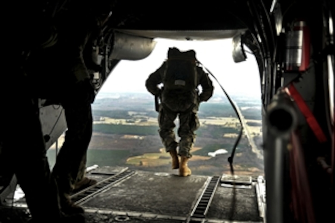 U.S. Navy SEALs jump from a CH-46E Sea Knight helicopter during training near Fort Pickett, Va., Dec. 20, 2011.