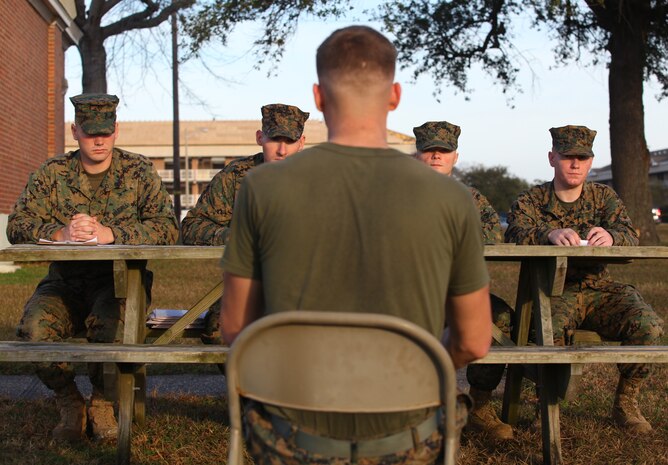 Lance Cpl. Jason Burch, an electronic intelligence intercept analyst/operator, with the Command Element, 24th Marine Expeditionary Unit, is interviewed during the final phase of a meritorious corporal promotion board by fellow Marines Dec. 20, 2011, outside the 24th MEU’s headquarters building aboard Camp Lejeune, N.C. Burch, a native of Marysville, Calif., was one of five Marines who was evaluated on various Marine Corps-centric activities, such as uniform inspections, Marine Corps knowledge tests, combat fitness training, and drill.