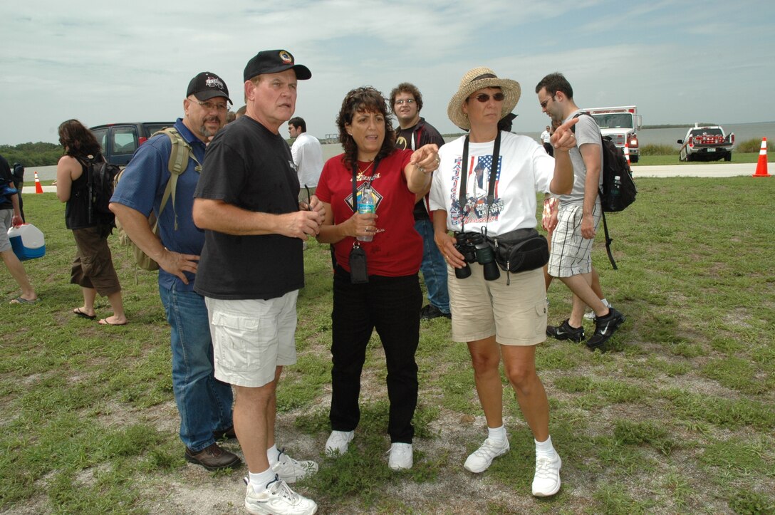 Toni Bearden of Detachment 1, 45th Mission Support Group (center in red shirt), directs guests at the 45th Space Wing VIP Viewing Area on the Cape Canaveral Air Force Station end of the NASA Causeway during the final launch of a Space Shuttle July 8, 2011. The successful STS-135 mission by Orbiter Atlantis marked the culmination of three decades of support of the shuttle program by the 45th Space Wing, other Air Force units and government agencies, and their mission partners on the Eastern Range. (U.S. Air Force photo/Eric Brian)