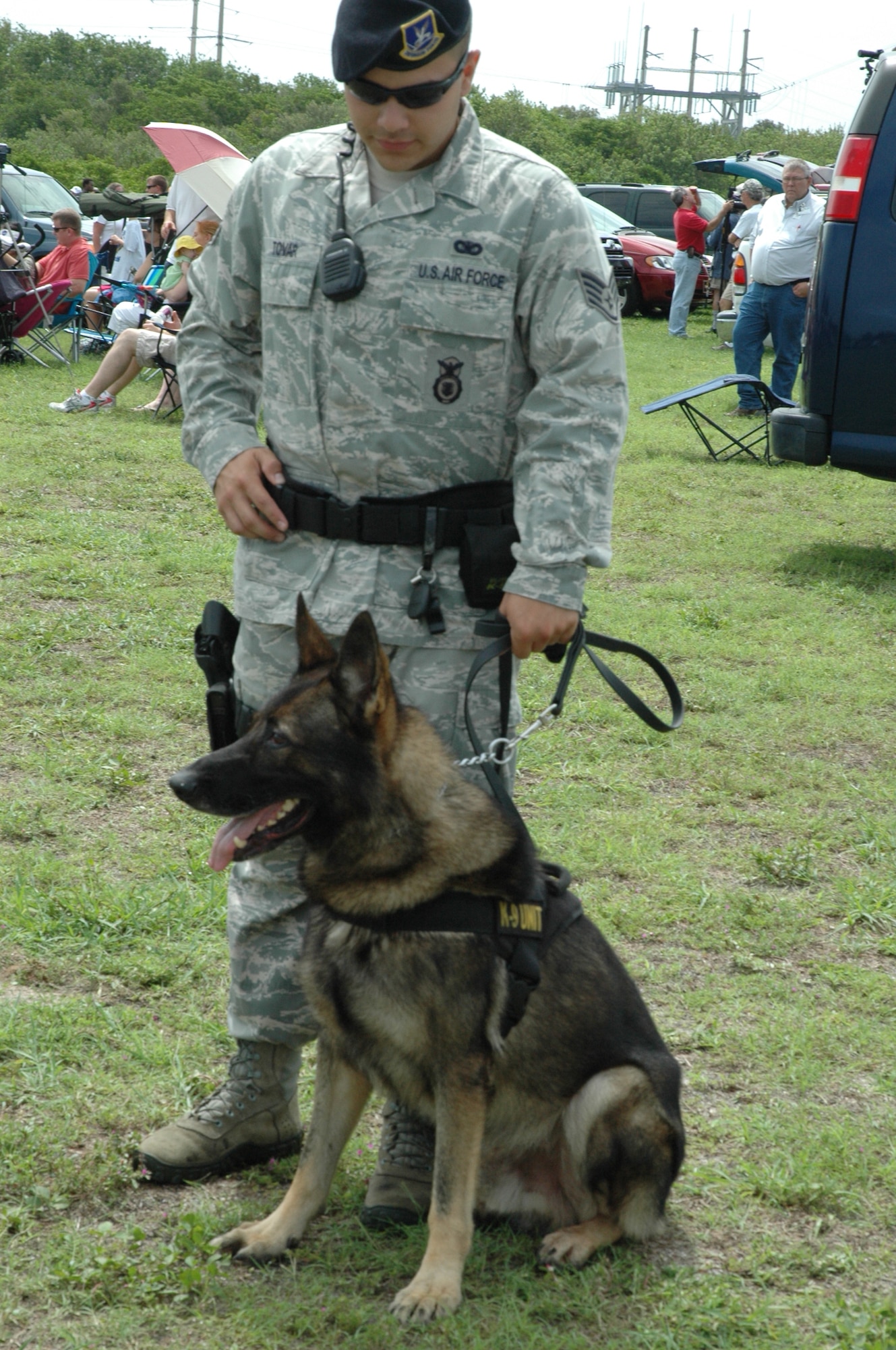 Staff Sgt. Andres Tovar and K-9 Ciro, 45th Security Forces Squadron, provide crowd safety and security at Cape Canaveral Air Force Station, Fla., for the final launch of a NASA Space Shuttle July 8, 2011. The successful STS-135 mission marked the culmination of three decades of support of the shuttle program by the 45th Space Wing, other Air Force units and government agencies, and their mission partners on the Eastern Range. (U.S. Air Force photo/Eric Brian)