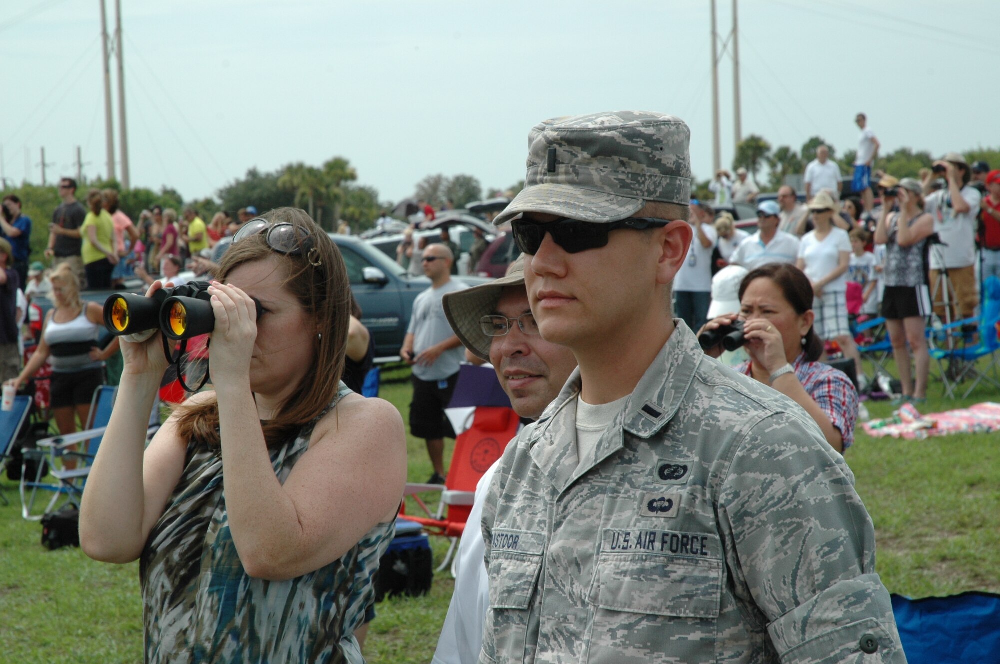 Crowds of U.S. Air Force members and their guests at Cape Canaveral AFS, Fla., watch the final launch of a space shuttle July 8, 2011, from the 45th Space Wing VIP Viewing Area on the NASA Causeway, as Shuttle Atlantis roars into the sky. The success of STS-135 marked the culmination of three decades of support for NASA Space Shuttle missions by the wing, other Air Force units and government agencies, and their mission partners. (U.S. Air Force photo/Eric Brian)