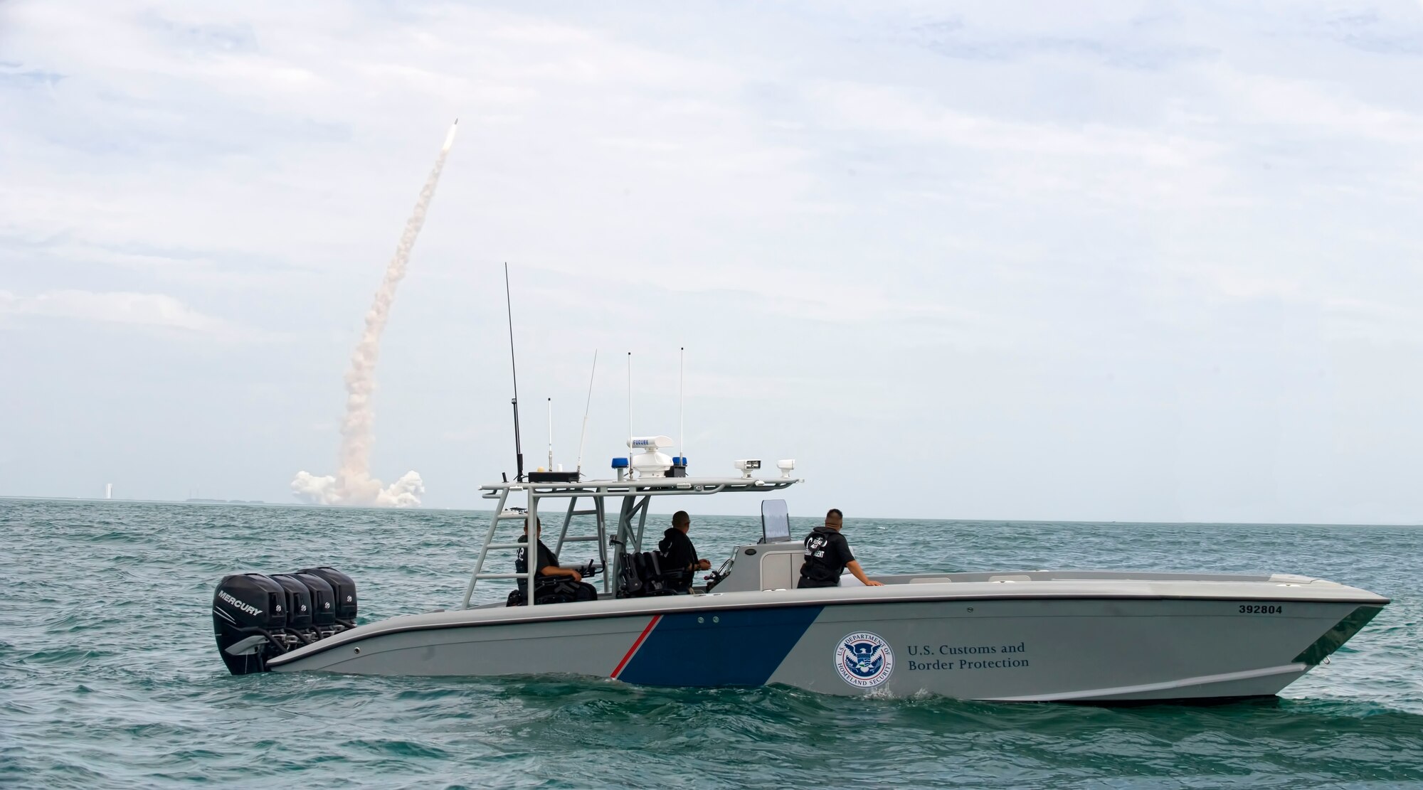 A U.S. Customs and Border Protection boat patrols the waters off Cape Canaveral AFS, Fla., during the last space shuttle launch July 8, 2011, from Kennedy Space Center. U.S. Air Force, Coast Guard and CBP personnel support space launches on the Eastern Range by securing the launch hazard area and restricted airspace. (U.S. Air Force photo/Julie Dayringer)