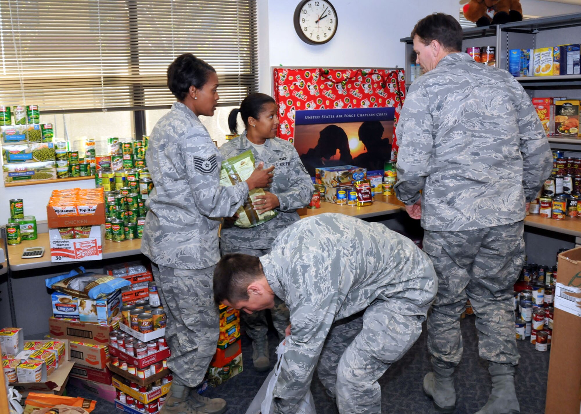 TRAVIS AIR FORCE BASE, Calif. -- 349th Air Mobility Wing's Chaplains office sorts the food item donations at the end of the annual wing food drive. (U.S. Air Force photo/Master Sgt. Robert Wade) 
