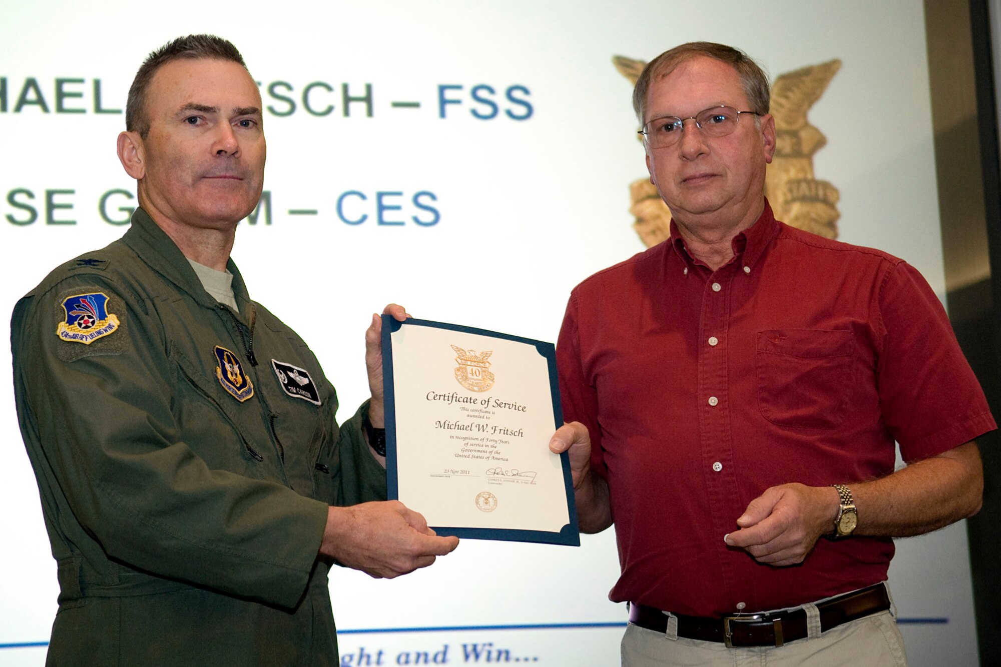 GRISSOM AIR RESERVE BASE, Ind. -- Col. William T. "Tim" Cahoon, 434th Air Refueling Wing commander, presents Michael Fritsch with a certificate and pin recognizing him for 40 years of federal civil service at a recent civilian commander's call here. Fritsch is a personnel systems specialist with the 434th Force Support Squadron. (U.S. Air Force photo/Tech. Sgt. Mark R. W. Orders-Woempner)
