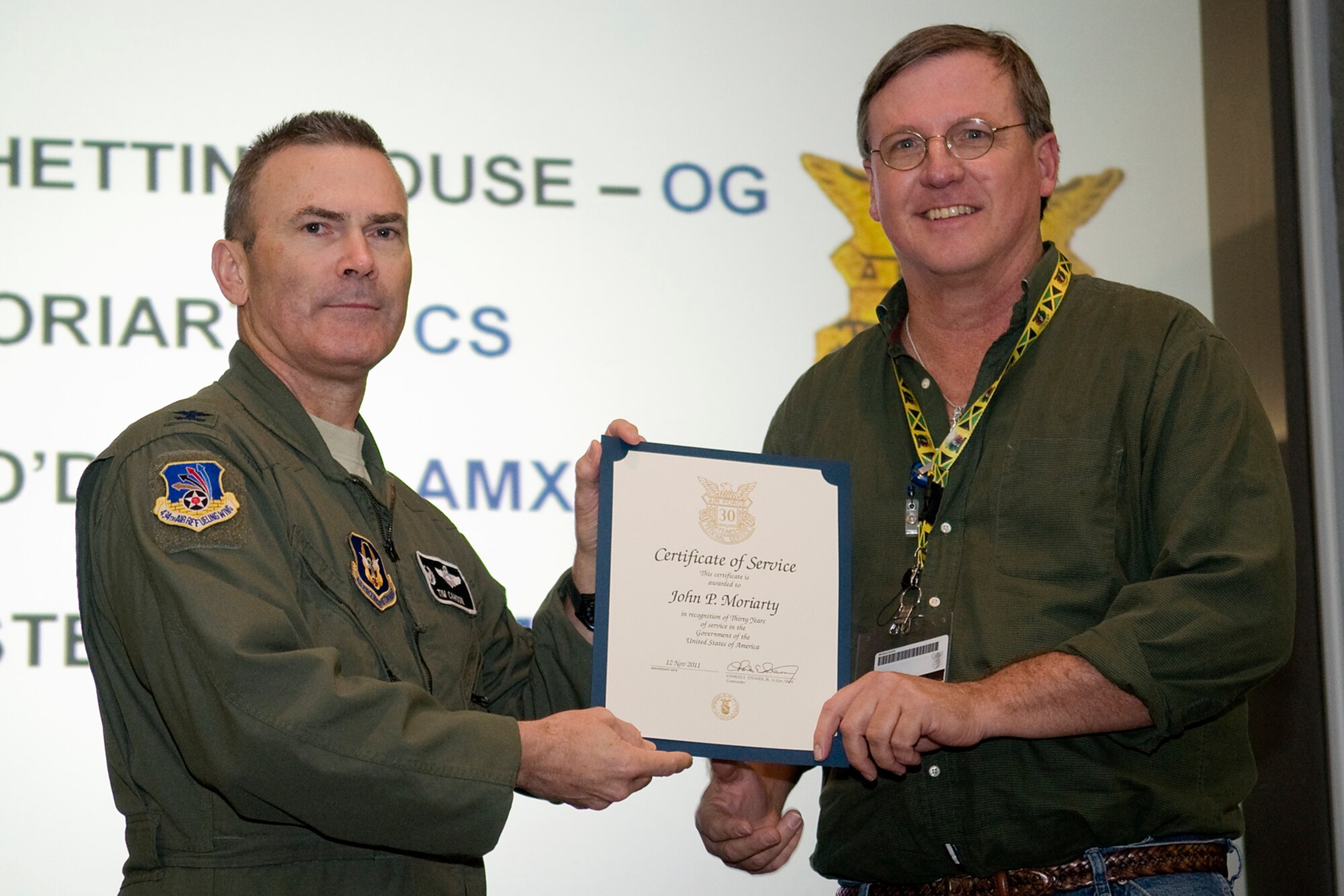 GRISSOM AIR RESERVE BASE, Ind. -- John Moriarty, 434th Communications Squadron airfield systems technician, receives his certificate of recognition for 30 years of civil service from Col. William T. "Tim" Cahoon, 434th Air Refueling Wing commander, during a civilian commander's call held here Dec 8. Moriarty, along with five other civilian employees were recognized for their civil service accomplishments. (U.S. Air Force photo/Tech. Sgt. Mark R. W. Orders-Woempner)
